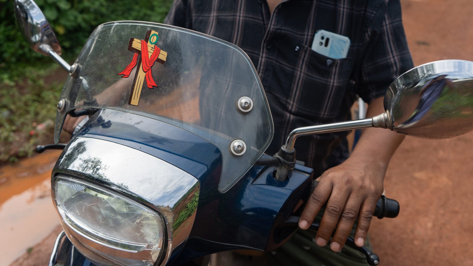 A motorcycle with a sticker of a cross on it.