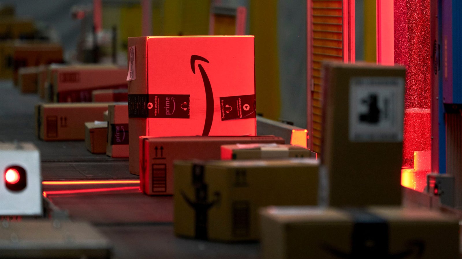 An automated bar code reader scans packages prepared for shipping at an Amazon Fulfillment.