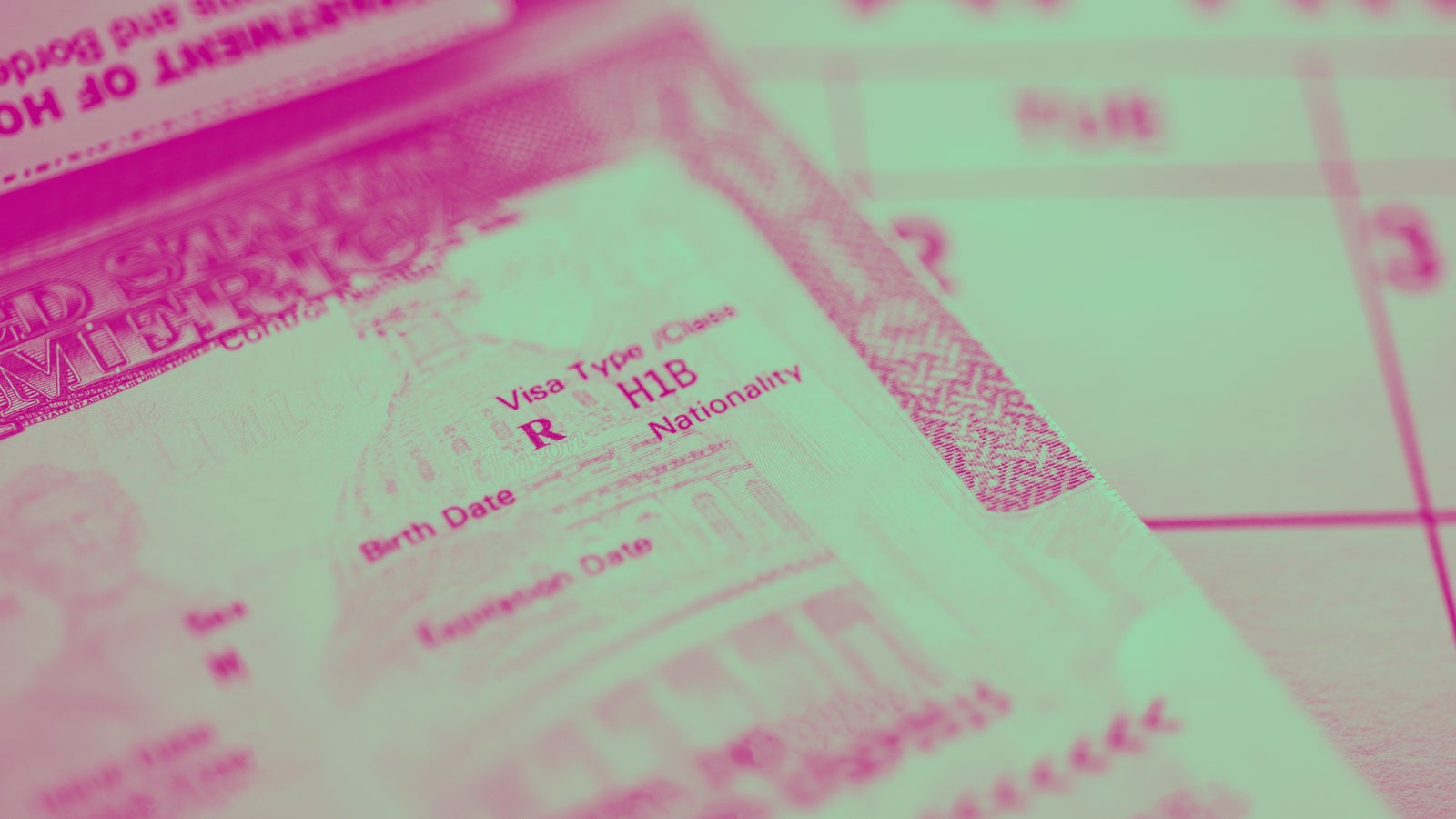 Close-up of a U.S. visa showing details such as visa type 'H1B,' with faint outlines of the U.S. Capitol building in the background, alongside a partially visible calendar in soft focus.