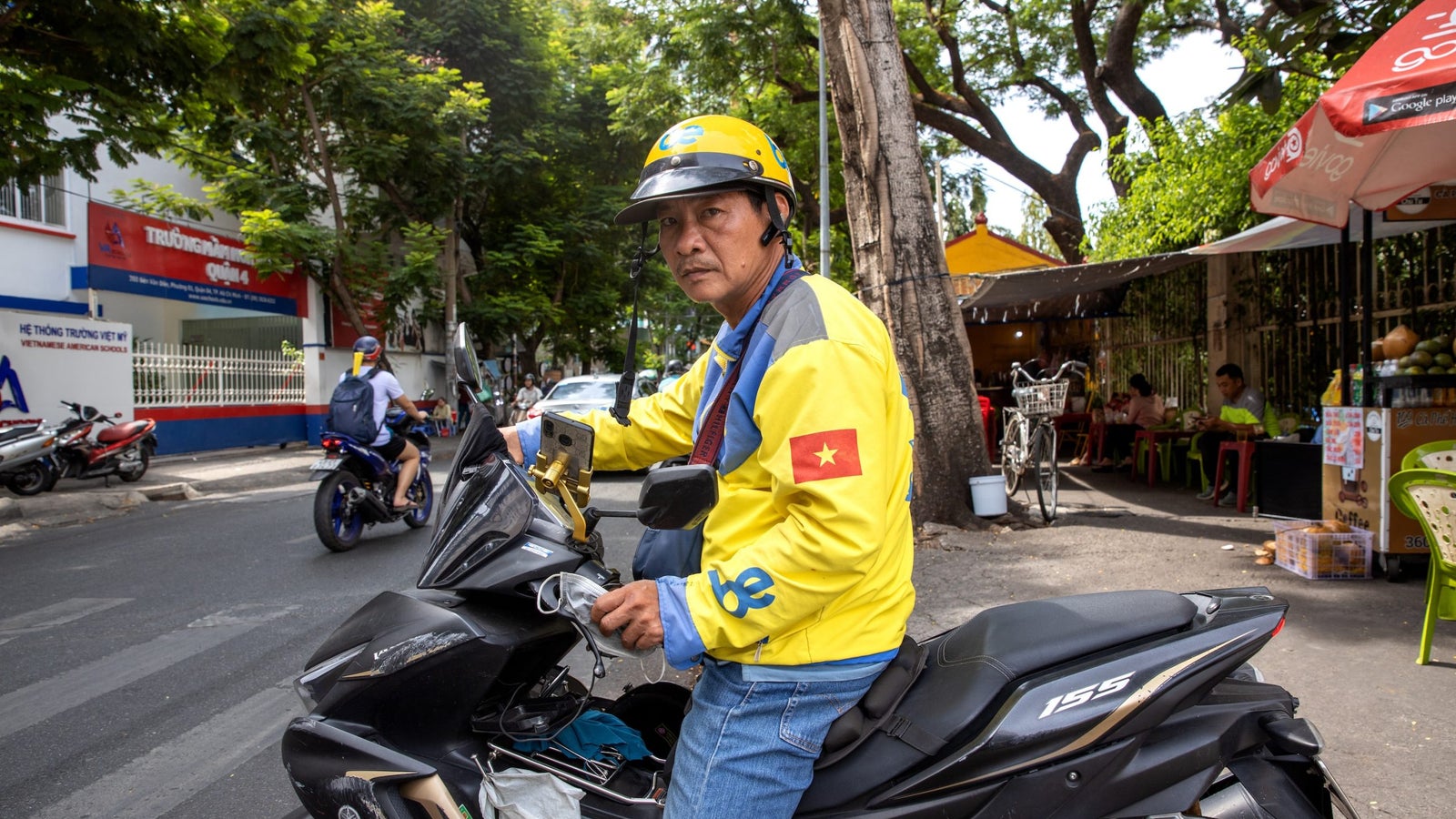 A portrait of Huynh Thanh Long on his motorcycle.