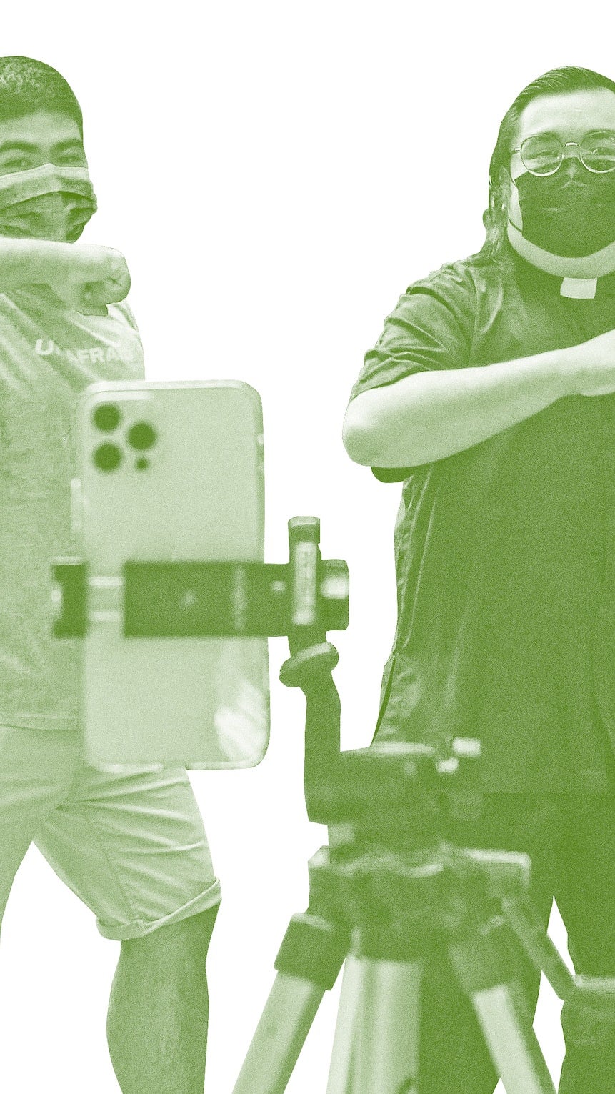 A photo of a two people dancing in front of a cell phone with a green overlay, against a white background.