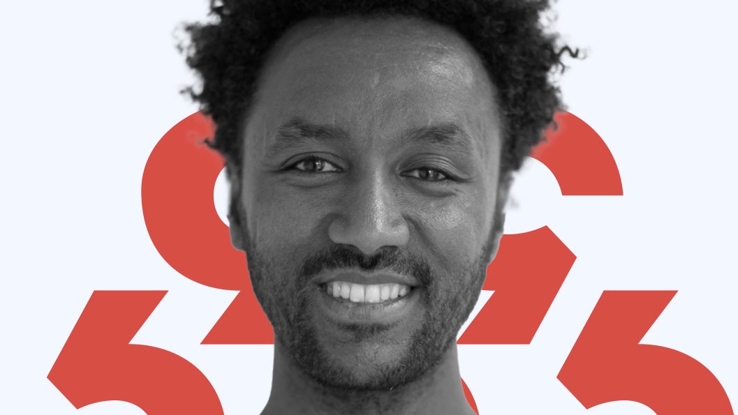A photo of Asmelash Teka Hadgu against a red and blue background.