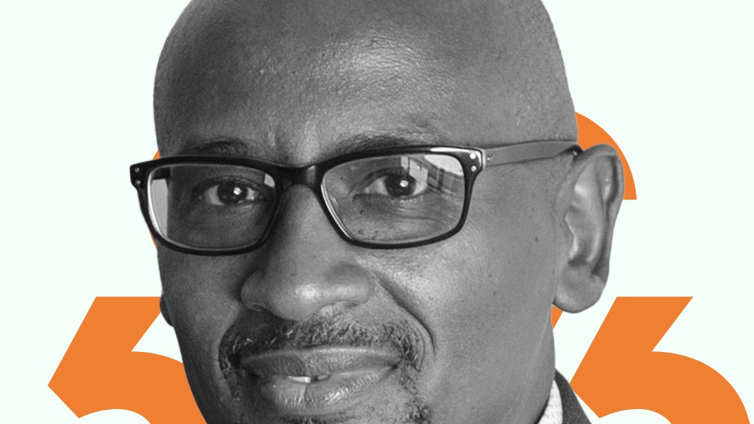 A black and white headshot of Joseph Nsengimana against an orange and light green background.