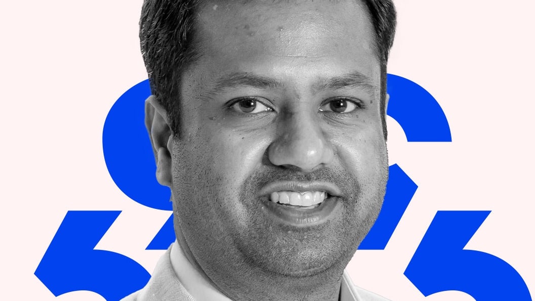 A black and white headshot of Ashish Singhal against a pink background with blue diacritics.