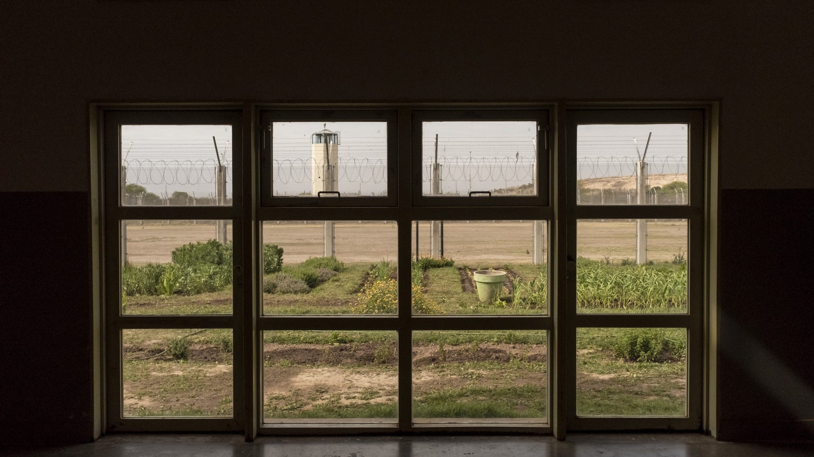 A photo looking out a window inside Bouwer Prison in Cordoba, Argentina.