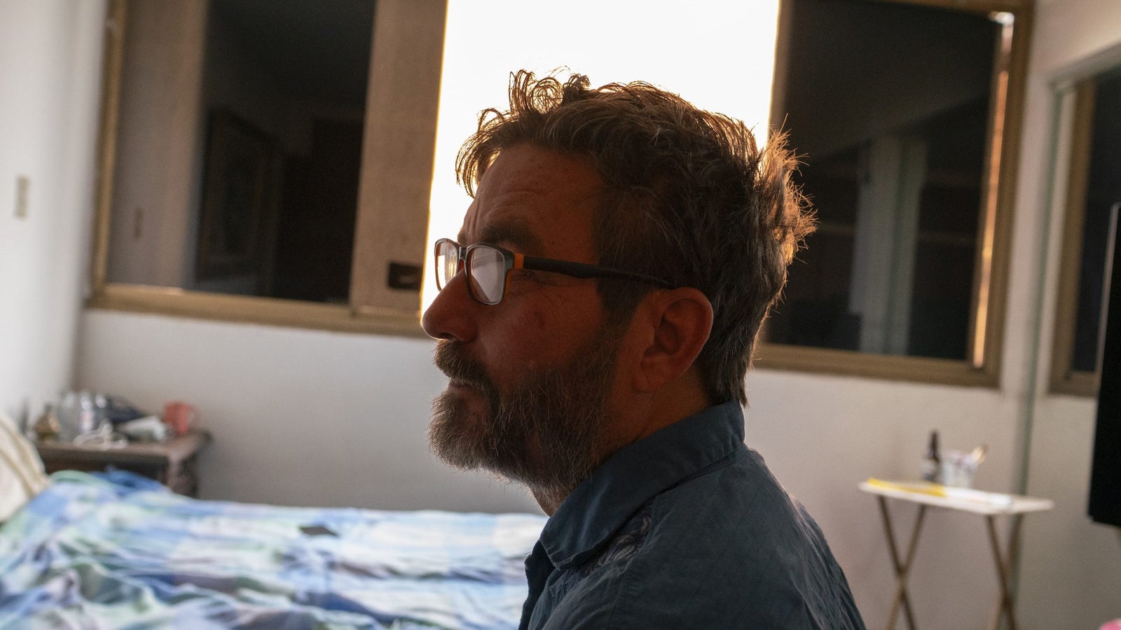 A side profile of Omar Alfonzo's face, taken in his bedroom.