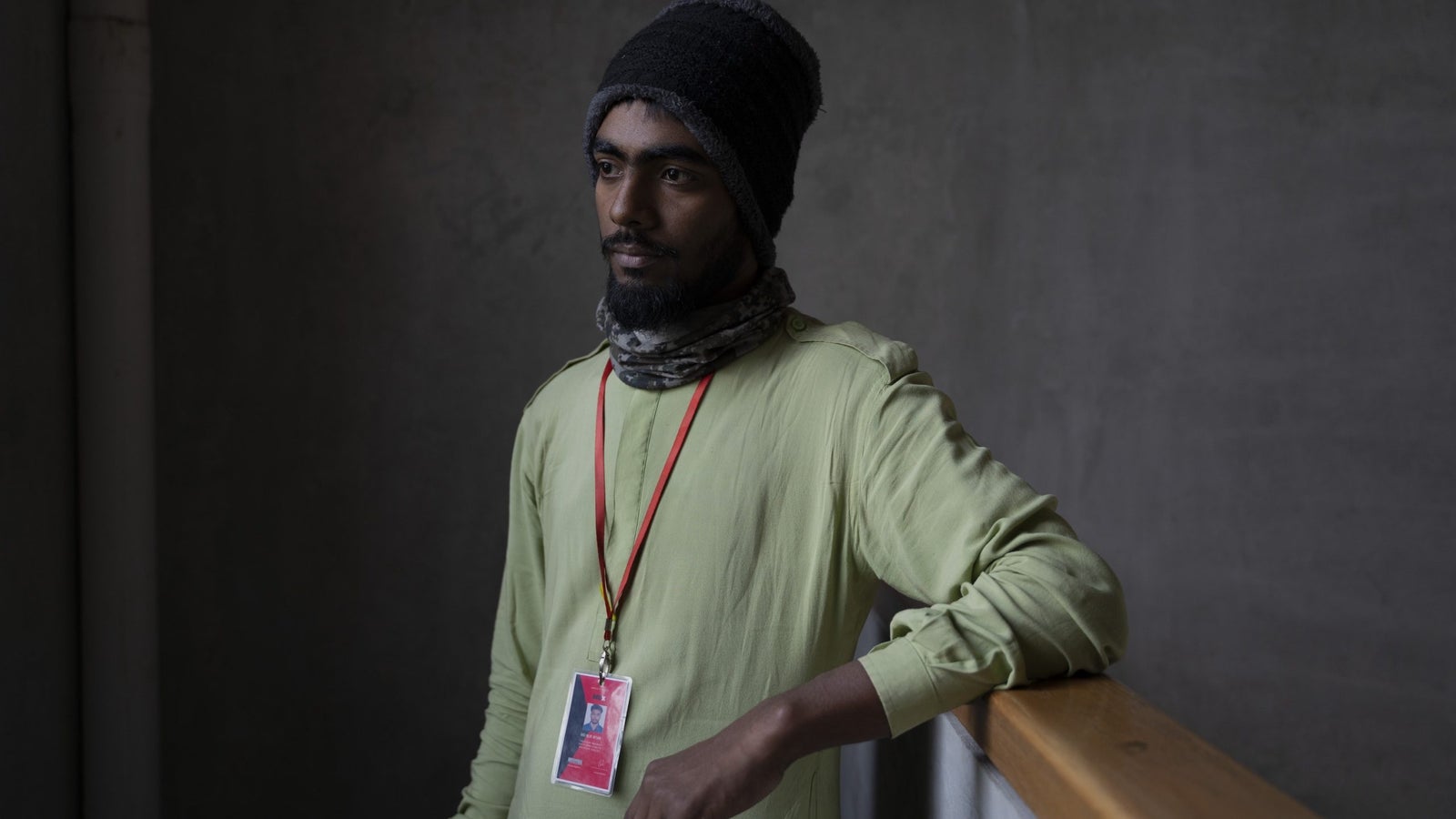 A portrait of RedX delivery rider MD. Nur Afsar taken indoors.