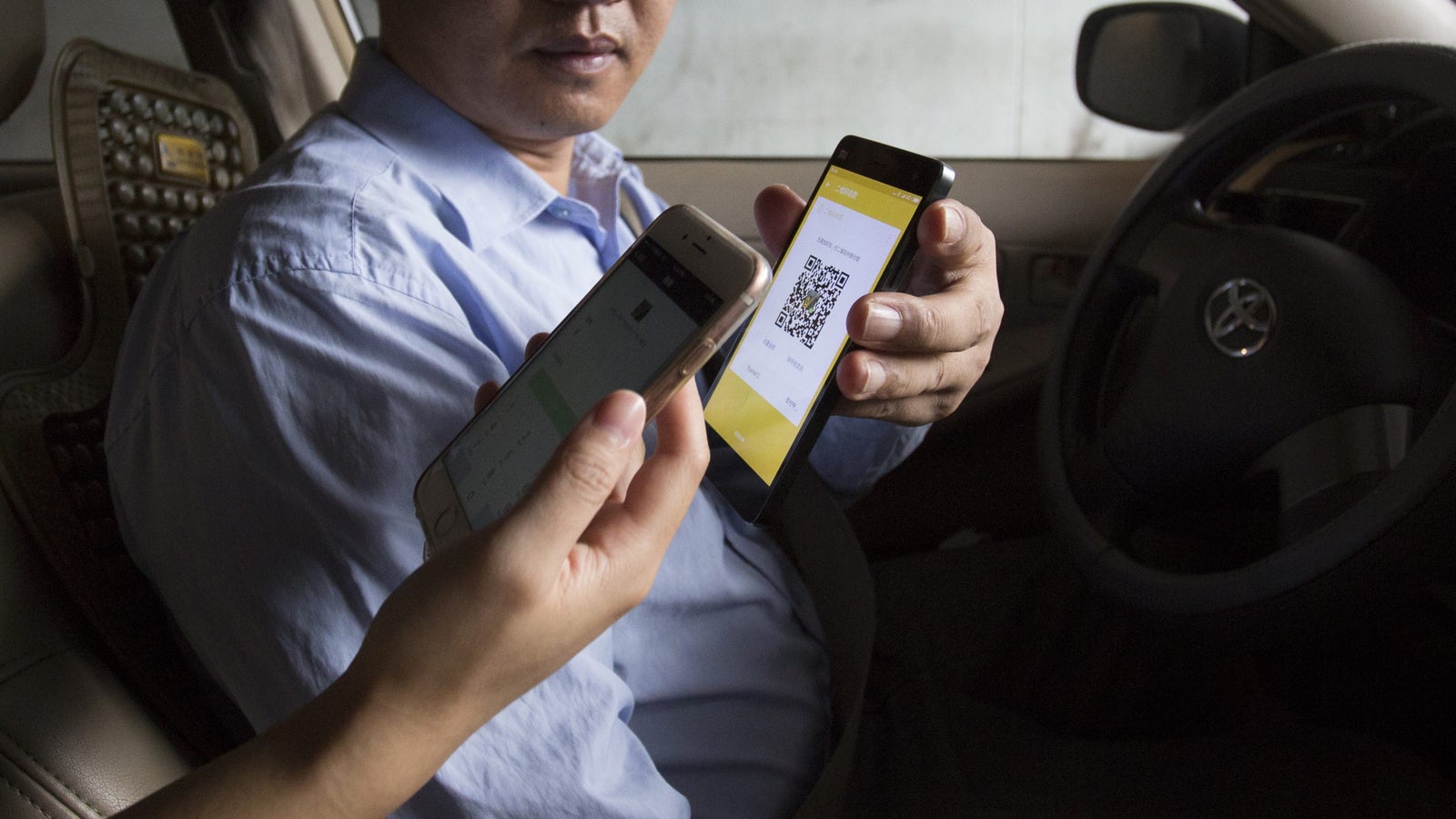 A person makes a payment using their phone.