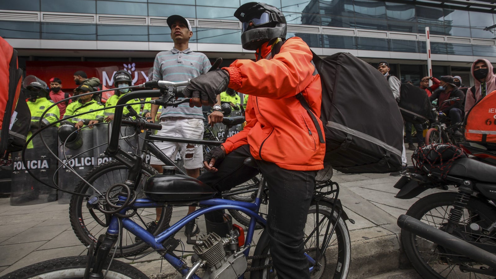 Rappi delivery rider using a bike with makeshift gas motor attachment.