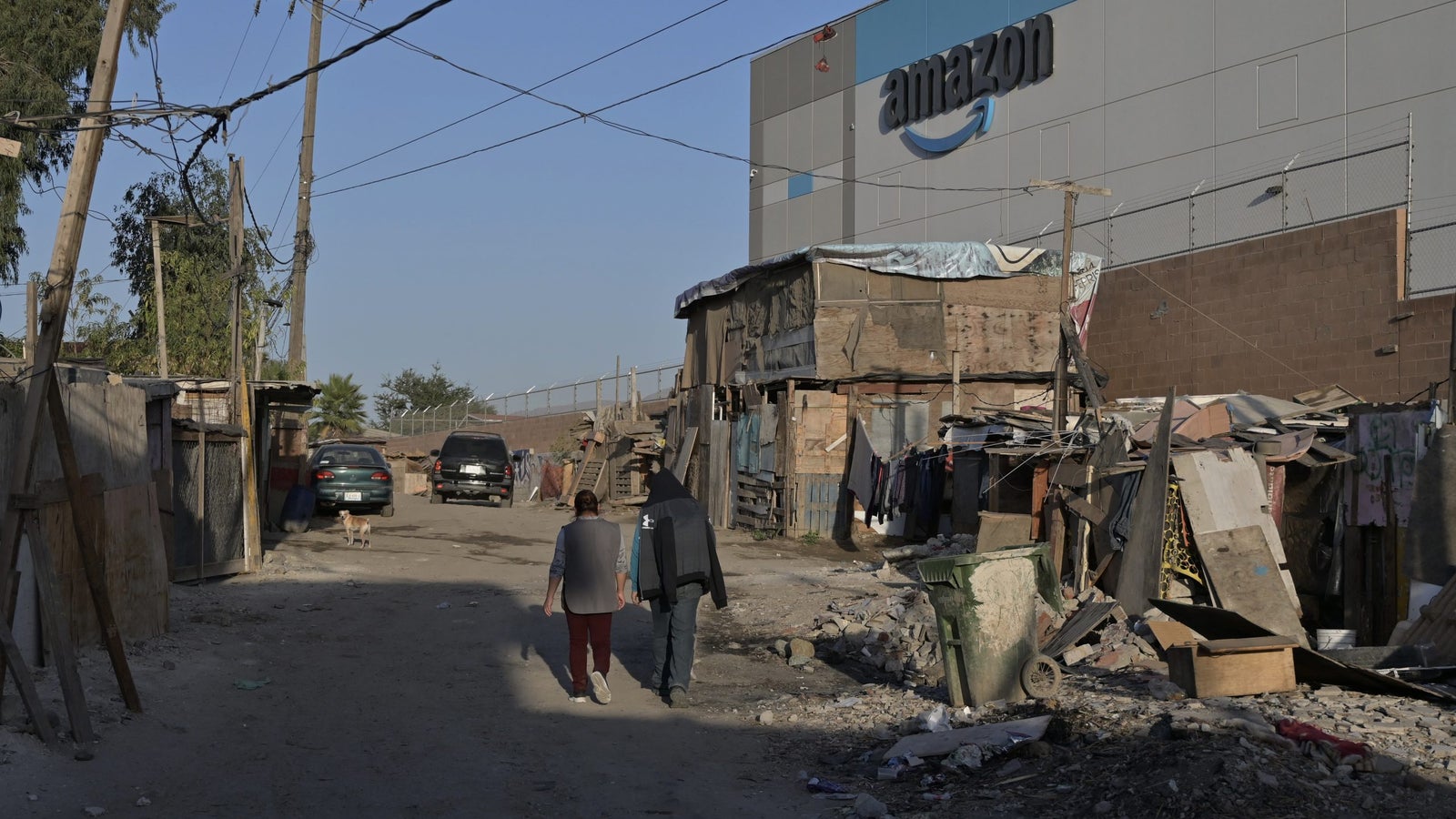 People walk past an Amazon warehouse in Tijuana, Mexico.