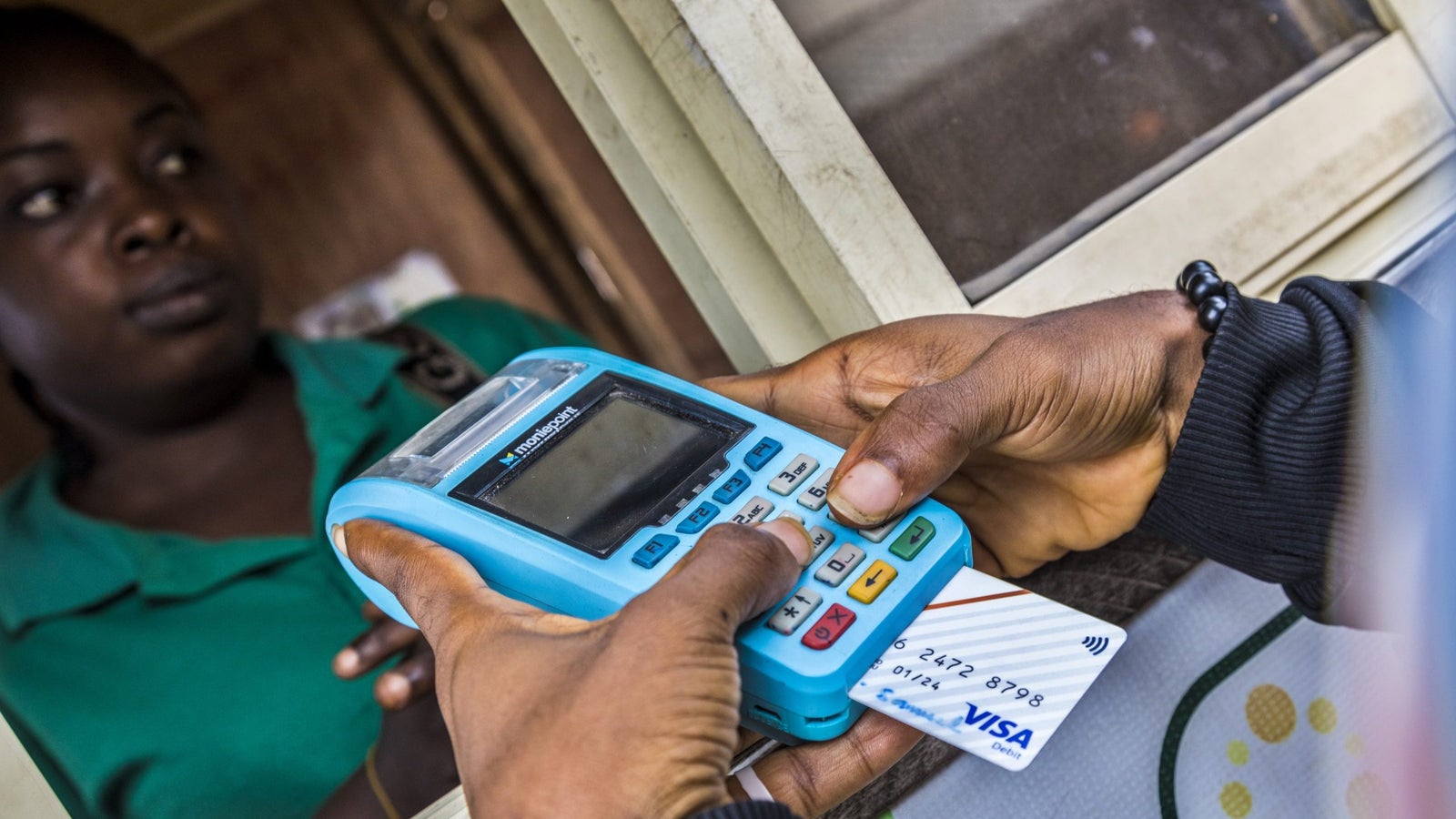 A customer validating his pin using a Moniepoint POS.