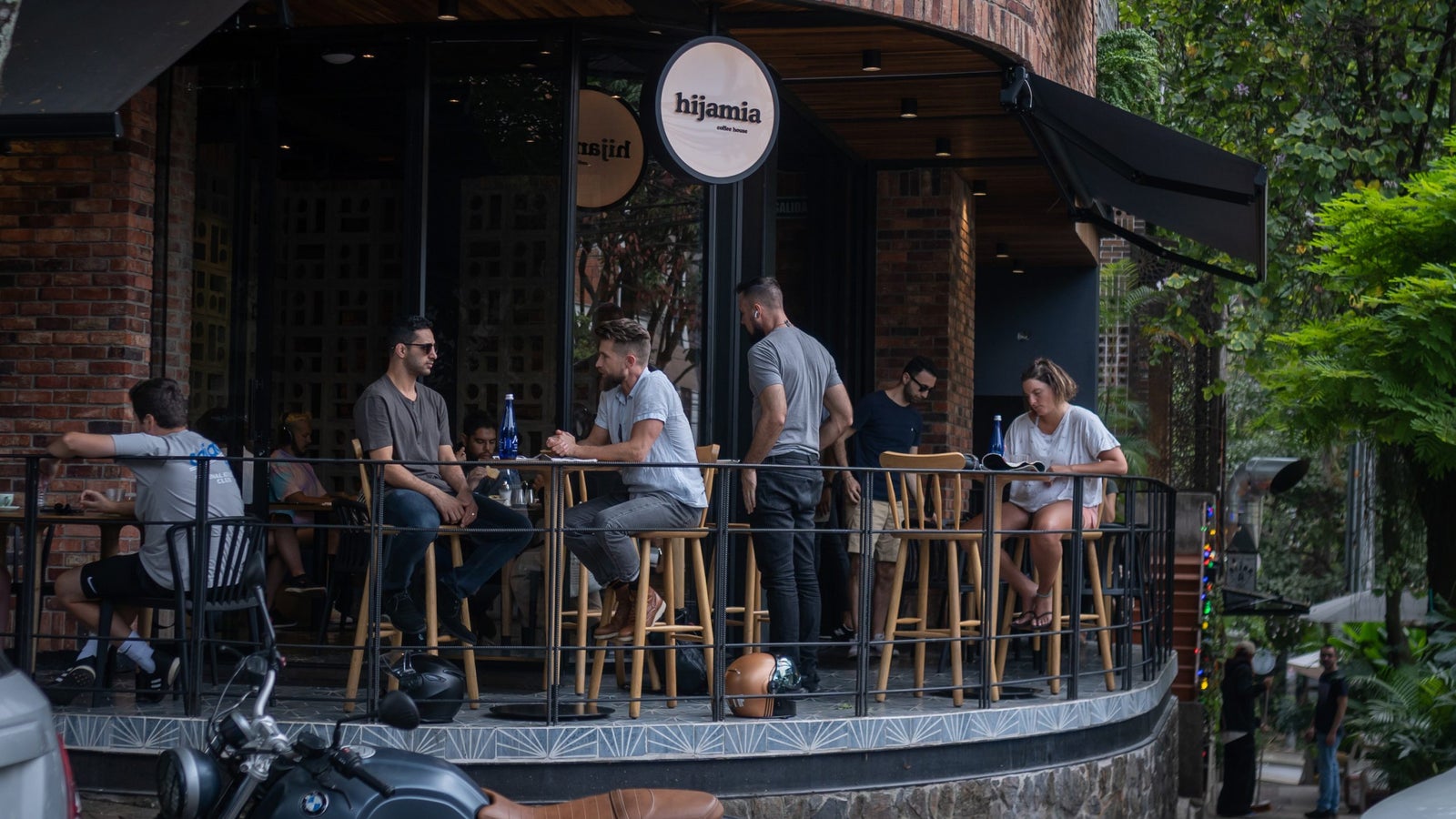 A photo of people hanging out on the patio of a coffee shop in Colombia.