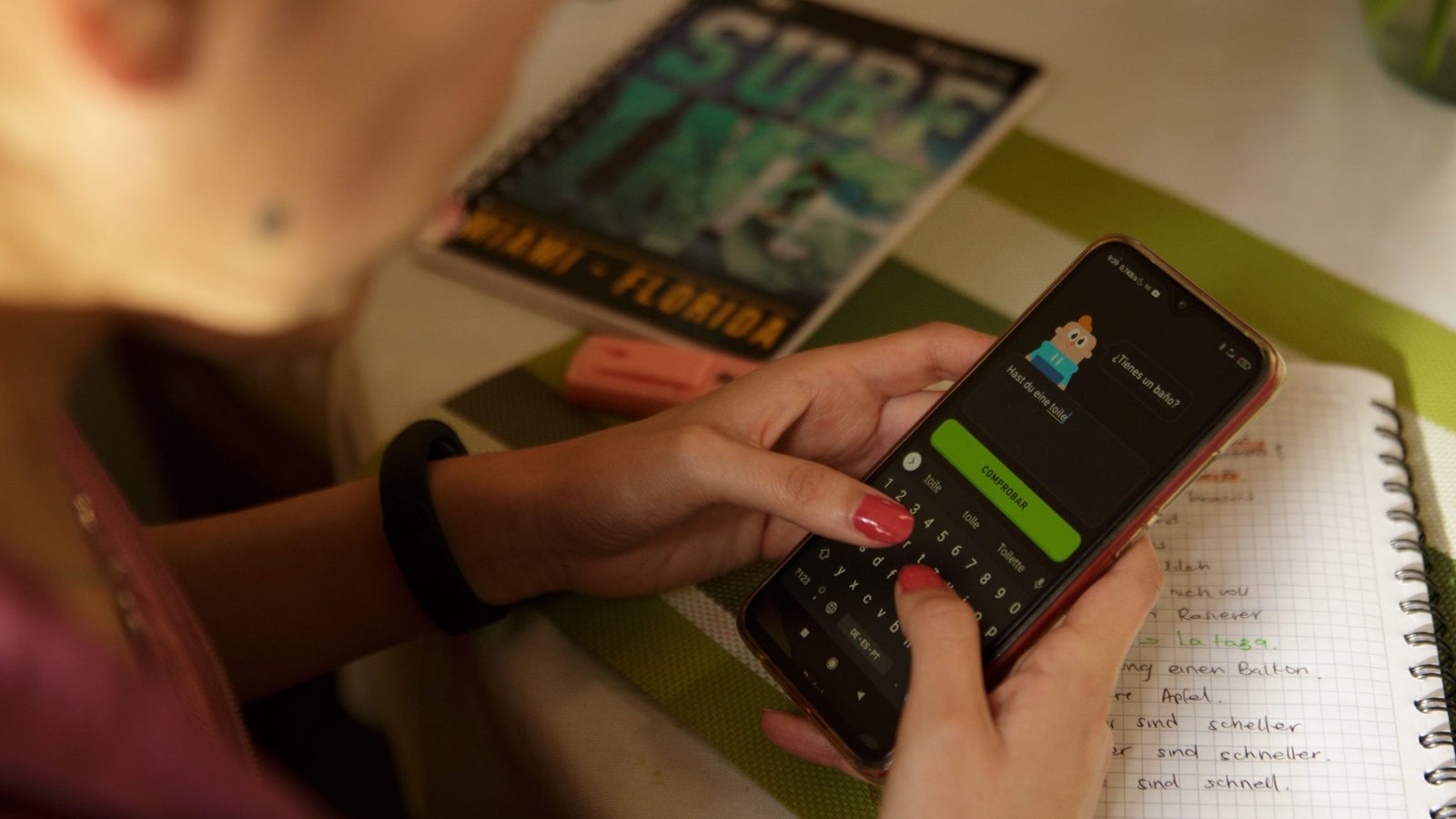 A photo of a person using the app Duolingo on their cell phone