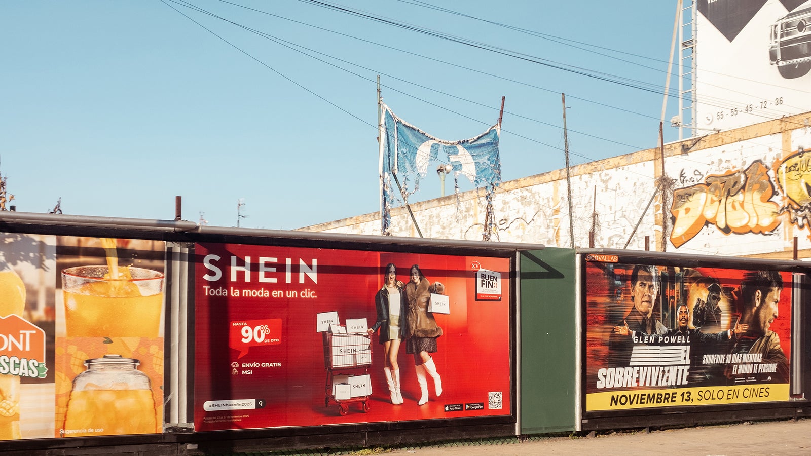 A colorful advertisement panel featuring promotions for SHEIN, drinks, and a movie called 'Sobreviviente', with urban graffiti in the background.