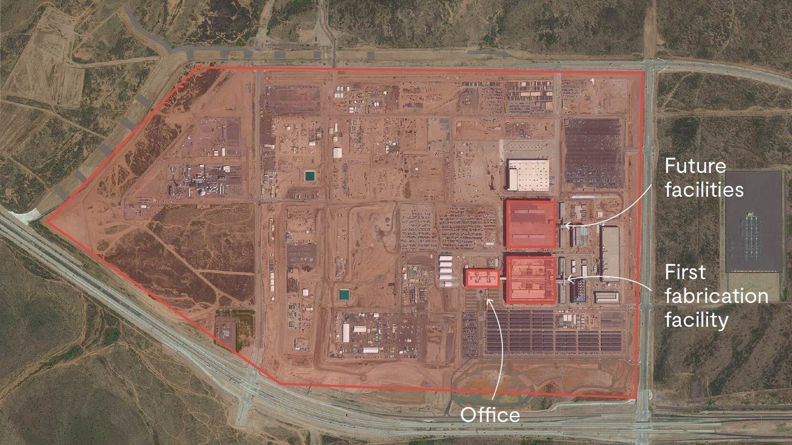 A annotated satellite photograph showing a large area of desert with a construction site and three building identified.