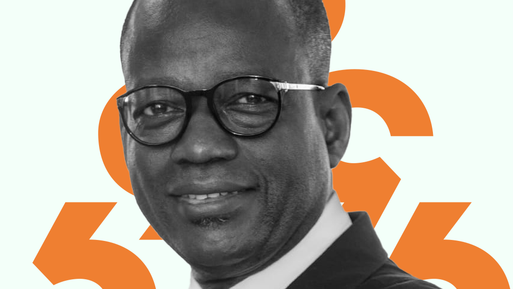 A photo of Lacina Kone against an orange diacritic background.